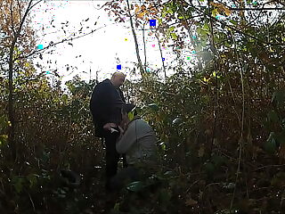 Elderly couple indulges in outdoor sex on a forest trail.